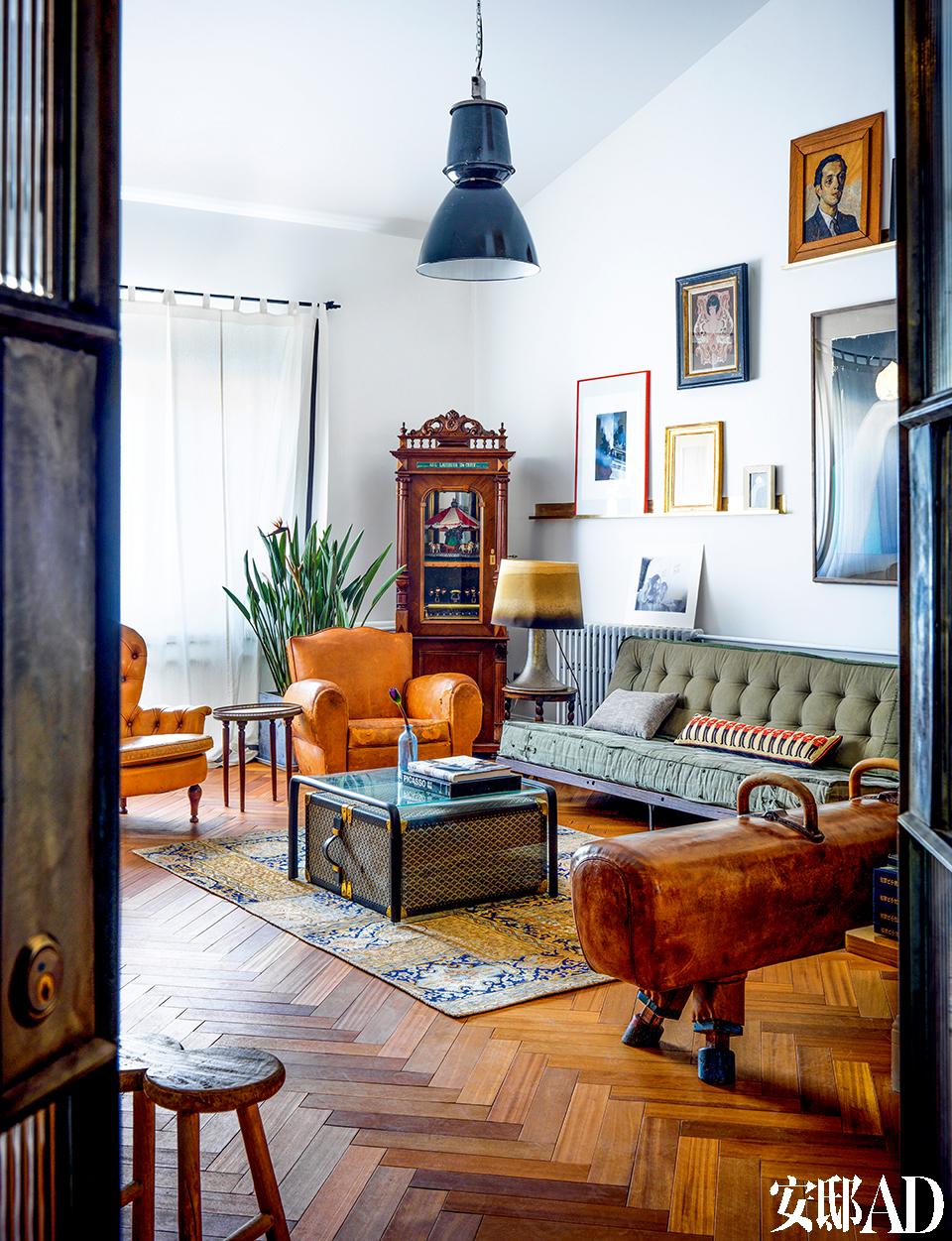 客厅里的布置风格，是主人把现当代艺术收藏、古董家具以及现代家饰巧妙结合的佐证。客厅地毯上方的小茶几底下，是主人在巴黎收藏的Vintage Goyard行李箱。