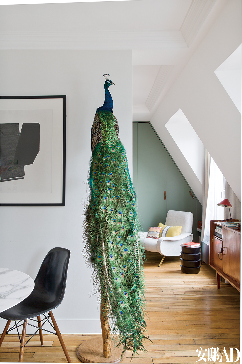 客厅的另一侧，墙上艺术品由Hans Hartung创作，极吸引眼球的孔雀标本摆件购自巴黎的Design et Nature。